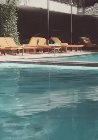 Pool with beach chairs around the perimeter.